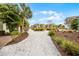 Lush landscaping featuring gravel pathways, mature trees, and colorful plants enhancing the home's outdoor appeal at 8012 Lost Shaker Ln, Kissimmee, FL 34747