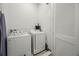 Laundry room features modern washer and dryer with built-in storage at 8012 Lost Shaker Ln, Kissimmee, FL 34747