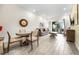 Bright living room with wood tile floors, a dining table and comfortable seating overlooking a backyard patio at 8012 Lost Shaker Ln, Kissimmee, FL 34747
