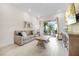 Comfortable living room with tile floors, a plush couch, and sliding glass doors to the outdoor patio at 8012 Lost Shaker Ln, Kissimmee, FL 34747