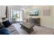 Cozy living room offers a comfortable sofa and access to an outdoor patio through sliding glass doors at 8012 Lost Shaker Ln, Kissimmee, FL 34747