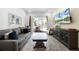 Comfortable living room features a plush sofa, stylish decor, and a view of the outdoor patio at 8012 Lost Shaker Ln, Kissimmee, FL 34747