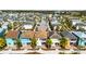 Charming home featuring a rear patio, outdoor seating, and colorful landscaping in a vibrant community at 8012 Lost Shaker Ln, Kissimmee, FL 34747