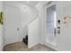 Welcoming staircase with wood steps and white railings leads to the upper level of the home at 8012 Lost Shaker Ln, Kissimmee, FL 34747
