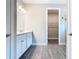 Bathroom featuring double sink vanity and wood-look tile flooring at 806 Via Como St, Poinciana, FL 34759