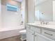 Bright bathroom with a tub-shower combination and a white single sink vanity at 806 Via Como St, Poinciana, FL 34759