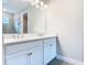 Bathroom showcasing double sinks, white cabinetry, and a large mirror at 806 Via Como St, Poinciana, FL 34759