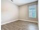 Bedroom with a window and wood-look tile flooring at 806 Via Como St, Poinciana, FL 34759