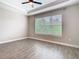 Bedroom with wood-look tile floors and large window providing natural light at 806 Via Como St, Poinciana, FL 34759
