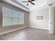 Spacious bedroom with a large window and wood-look tile flooring at 806 Via Como St, Poinciana, FL 34759