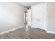 Bedroom with wood-look tile flooring near closets and hallway at 806 Via Como St, Poinciana, FL 34759