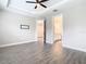 Bedroom with wood-look tile flooring and access to a bathroom at 806 Via Como St, Poinciana, FL 34759