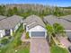 Aerial view of home with a brick paved driveway and two car garage at 806 Via Como St, Poinciana, FL 34759