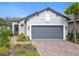 Inviting single-story home with a two-car garage, brick driveway, and appealing curb appeal at 806 Via Como St, Poinciana, FL 34759