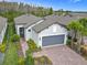 Beautiful single-story home featuring a two-car garage, brick driveway, and lush landscaping at 806 Via Como St, Poinciana, FL 34759