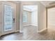 A foyer with tile floors leading to a bedroom and other rooms, with views of the tray ceilings at 806 Via Como St, Poinciana, FL 34759