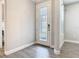 The foyer features a decorative front door, wood-look tile flooring, and neutral wall paint at 806 Via Como St, Poinciana, FL 34759