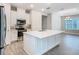 Contemporary kitchen features an island with quartz countertops, modern appliances, and stylish tile backsplash at 806 Via Como St, Poinciana, FL 34759