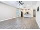 Bright and spacious living room showcasing wood-look tile floors and an open layout to the modern kitchen at 806 Via Como St, Poinciana, FL 34759