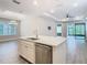 Kitchen island with stainless steel appliances sink and white cabinets and an open floor plan at 806 Via Como St, Poinciana, FL 34759