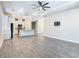 Open concept living area with wood-look tile floors and a kitchen island perfect for entertaining guests at 806 Via Como St, Poinciana, FL 34759