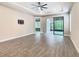 Main bedroom with tile floors, tray ceilings, sliding glass doors, and recessed lighting at 806 Via Como St, Poinciana, FL 34759