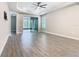 Spacious main bedroom featuring tile floors, a tray ceiling, and a sliding glass door at 806 Via Como St, Poinciana, FL 34759