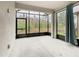 Screened patio with views of green foliage and an adjacent window with curtain at 806 Via Como St, Poinciana, FL 34759