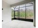Screened patio with views of green foliage at 806 Via Como St, Poinciana, FL 34759