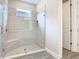 Glass enclosed shower featuring stylish tiling and built-in bench at 806 Via Como St, Poinciana, FL 34759