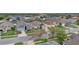 Aerial view of a neighborhood featuring manicured lawns and mature trees at 923 Tramells Trl, Kissimmee, FL 34744