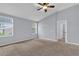Bright bedroom featuring two windows and neutral carpet, offering a comfortable and inviting space at 923 Tramells Trl, Kissimmee, FL 34744