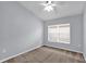 Neutral bedroom with clean carpet, white trim, and a bright window at 923 Tramells Trl, Kissimmee, FL 34744