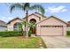 Charming single-story home with a well-manicured lawn and inviting curb appeal at 923 Tramells Trl, Kissimmee, FL 34744