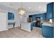 Open concept kitchen with blue cabinets, stainless appliances, and tile floors at 923 Tramells Trl, Kissimmee, FL 34744