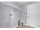 Functional laundry room with shelving and tile floors, ready for washer and dryer hookups at 923 Tramells Trl, Kissimmee, FL 34744