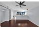 Bright, open-concept living area with hardwood floors and view into the modern kitchen at 923 Tramells Trl, Kissimmee, FL 34744