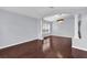 Open living room space with hardwood floors, neutral walls, and pillars at 923 Tramells Trl, Kissimmee, FL 34744