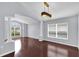 Elegant living room featuring hardwood floors, arched entryway, and stylish light fixture at 923 Tramells Trl, Kissimmee, FL 34744