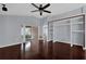 Main bedroom with hardwood floors, ceiling fan, closet and access to patio at 923 Tramells Trl, Kissimmee, FL 34744