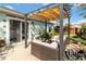 Outdoor patio features a wicker seating area under a pergola with a sunny view of the yard at 9559 Dubois Blvd, Orlando, FL 32825