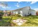 Spacious backyard with a stone walkway, green lawn, and outdoor seating area at 9559 Dubois Blvd, Orlando, FL 32825