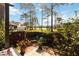 Landscaped backyard with serene lake views, enclosed by a wooden fence and lush greenery at 9559 Dubois Blvd, Orlando, FL 32825