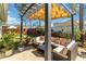 Inviting outdoor seating under a shaded pergola creates a cozy and relaxing backyard space at 9559 Dubois Blvd, Orlando, FL 32825