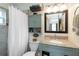 Charming bathroom with gray granite counters, storage cabinets, and shower with curtain at 9559 Dubois Blvd, Orlando, FL 32825