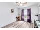 Bright bedroom features modern wood floors, a ceiling fan, and a functional workspace at 9559 Dubois Blvd, Orlando, FL 32825