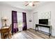 Bright bedroom features modern wood floors, a ceiling fan, and a functional workspace at 9559 Dubois Blvd, Orlando, FL 32825