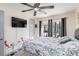 Comfortable bedroom with ceiling fan, flower-themed decoration, and sliding door access to the patio at 9559 Dubois Blvd, Orlando, FL 32825