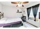 Small bedroom with a comfortable bed, desk, and light from the window at 9559 Dubois Blvd, Orlando, FL 32825