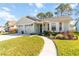 Inviting single-story home featuring a well-kept lawn and cozy front garden at 9559 Dubois Blvd, Orlando, FL 32825